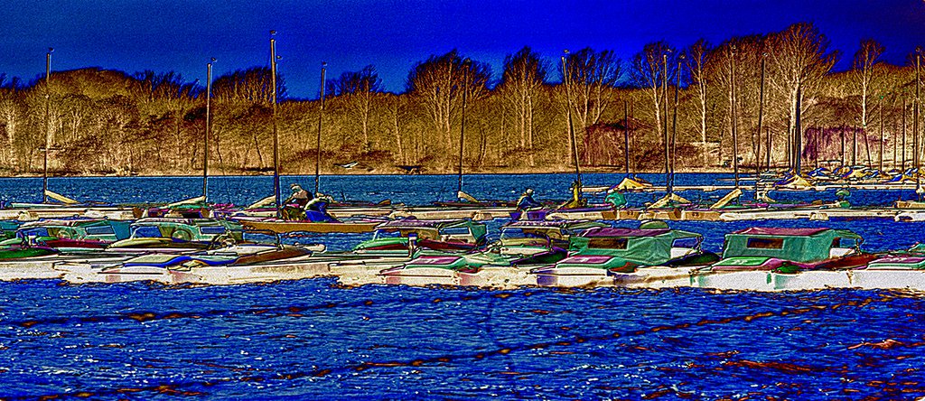 Autumn On The Lake - a panoramic depiction of an afternoon scene of strong colours on a lake with boats in late autumn